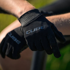 Man die CUBE Fietshandschoenen aantrekt